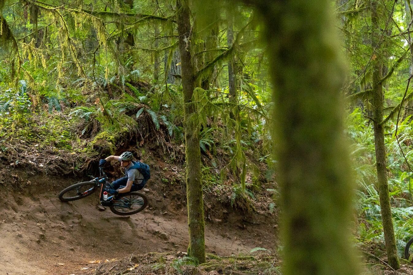 A mountain bike rider learns to ride a berm in Oakridge, Oregon. 