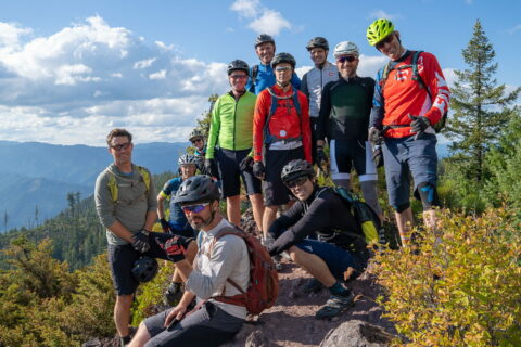 A group of friends pose for a photo during a guided mountain bike ride in Oregon. 