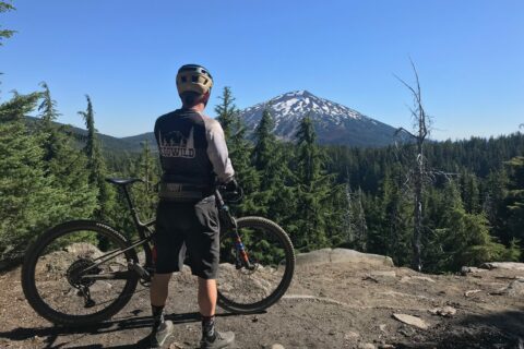 A mountain biker takes in the view of Mt. Bachelor.